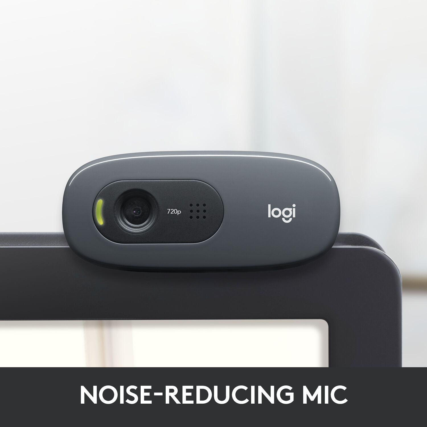 Logitech C270 HD webcam mounted on monitor showing noise-reducing mic feature and 720p branding